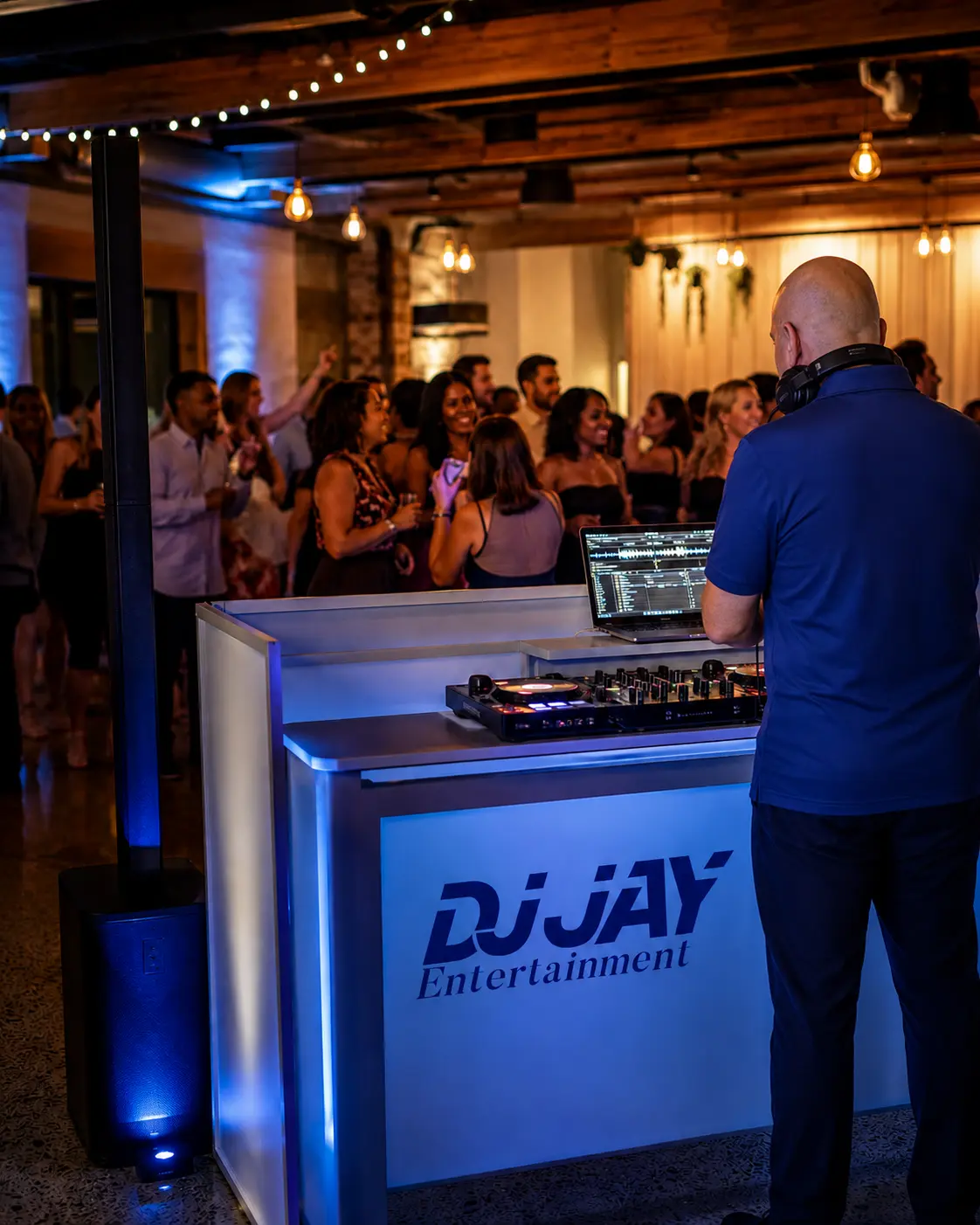 Jay Hembree of DJ Jay Entertainment performing behind his professional DJ booth