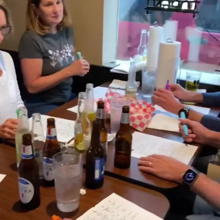 A table of guests playing DJ Jay's Hit-List Bingo together