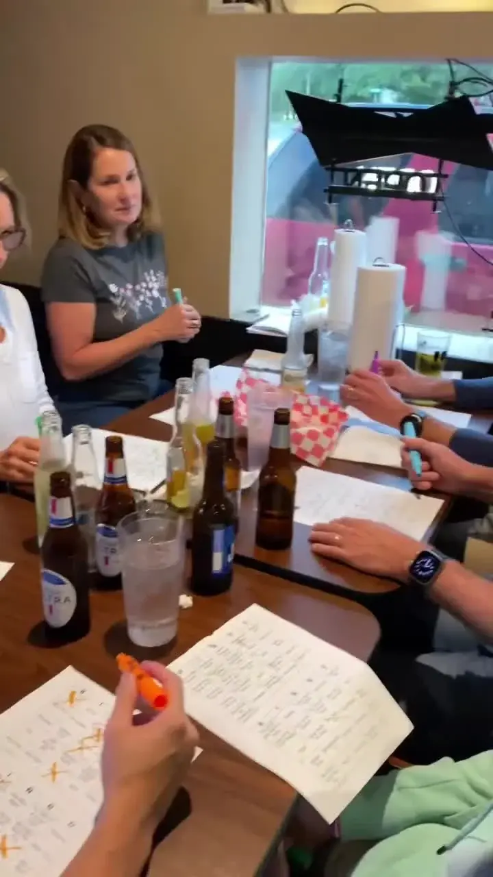 Guests marking printed Hit-List Bingo music bingo cards at a local venue