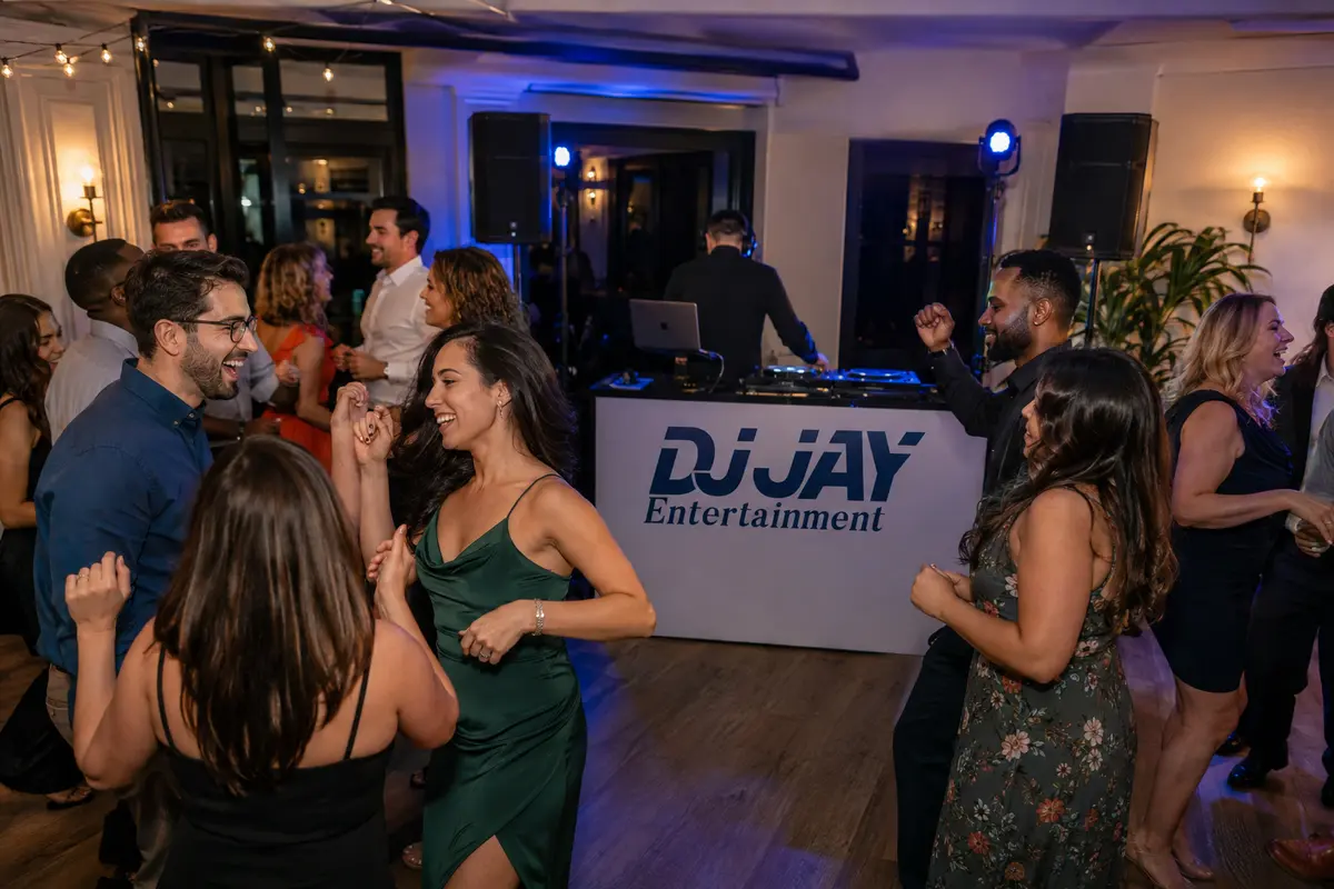 Guests dancing at a private party with a professional DJ setup