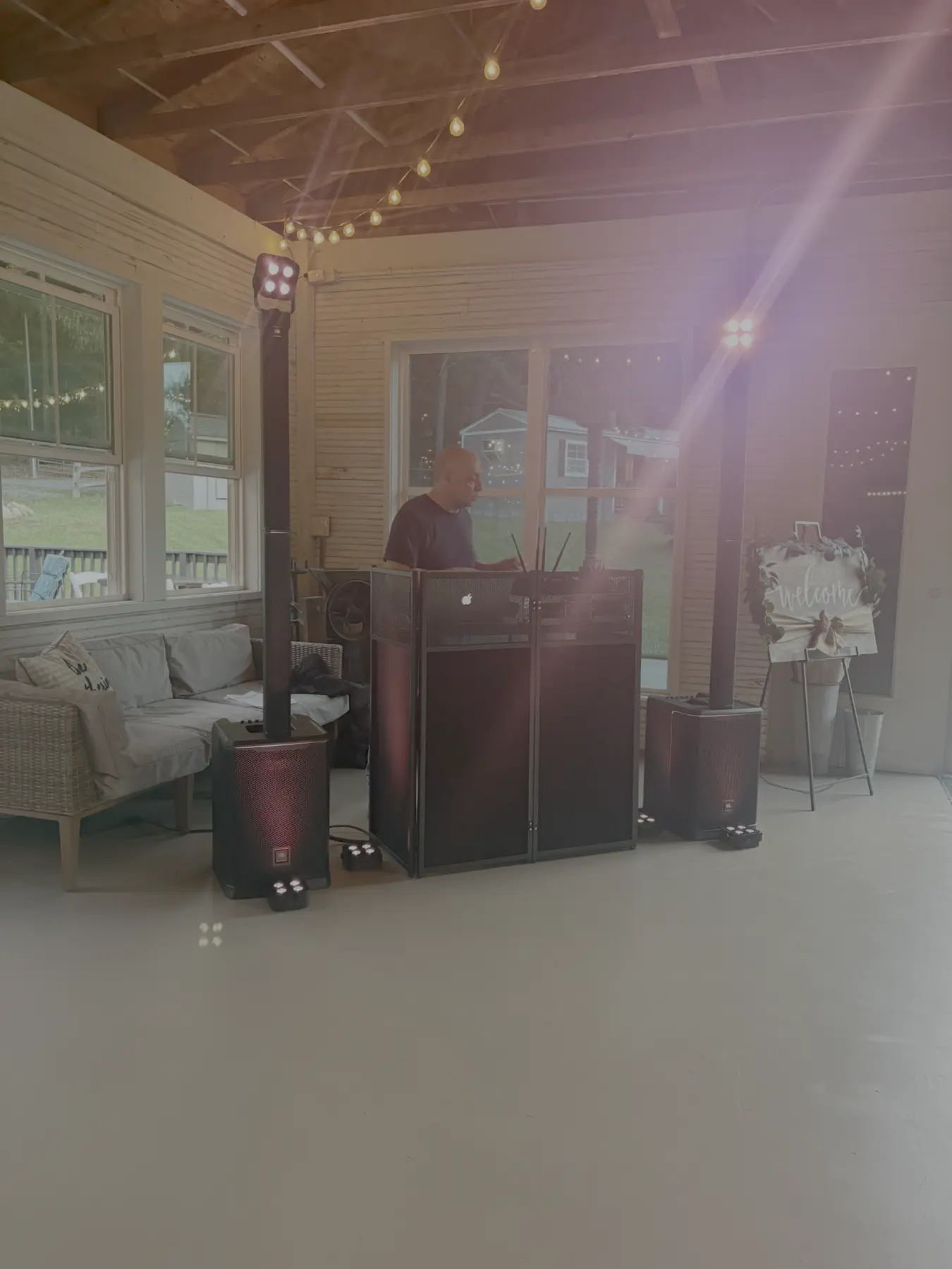 DJ Jay behind his professional booth at a wedding venue